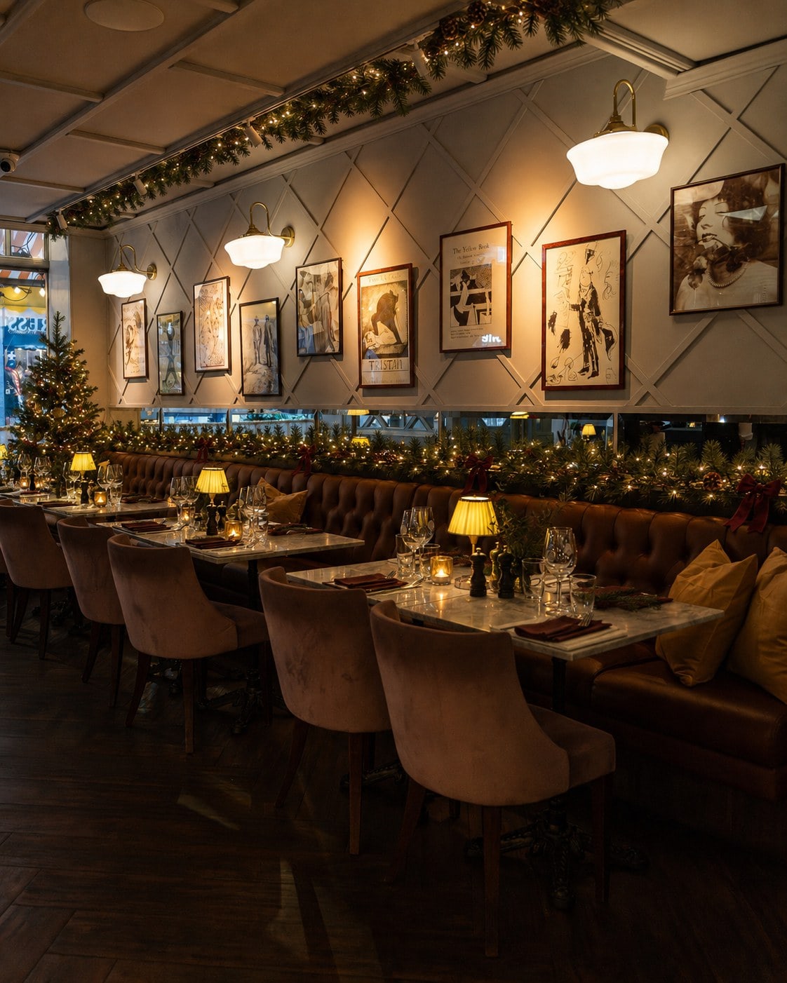 The banquette seating at Rydbergs at Christmas with garlands, table lamps and the picture wall